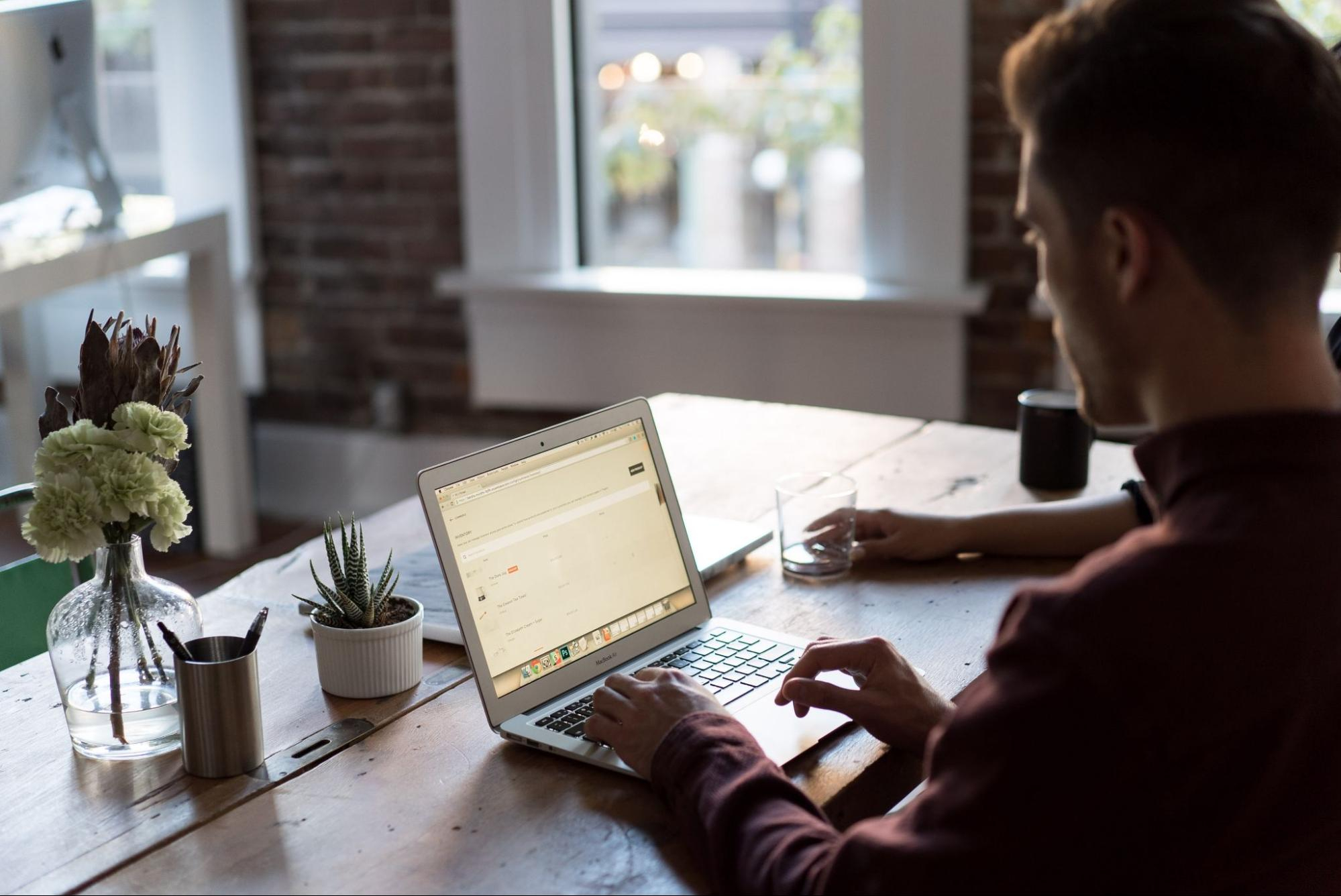 A man at a desk with a laptop